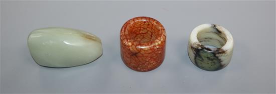 A Chinese Celadon jade pebble snuff bottle and two hardstone archers rings